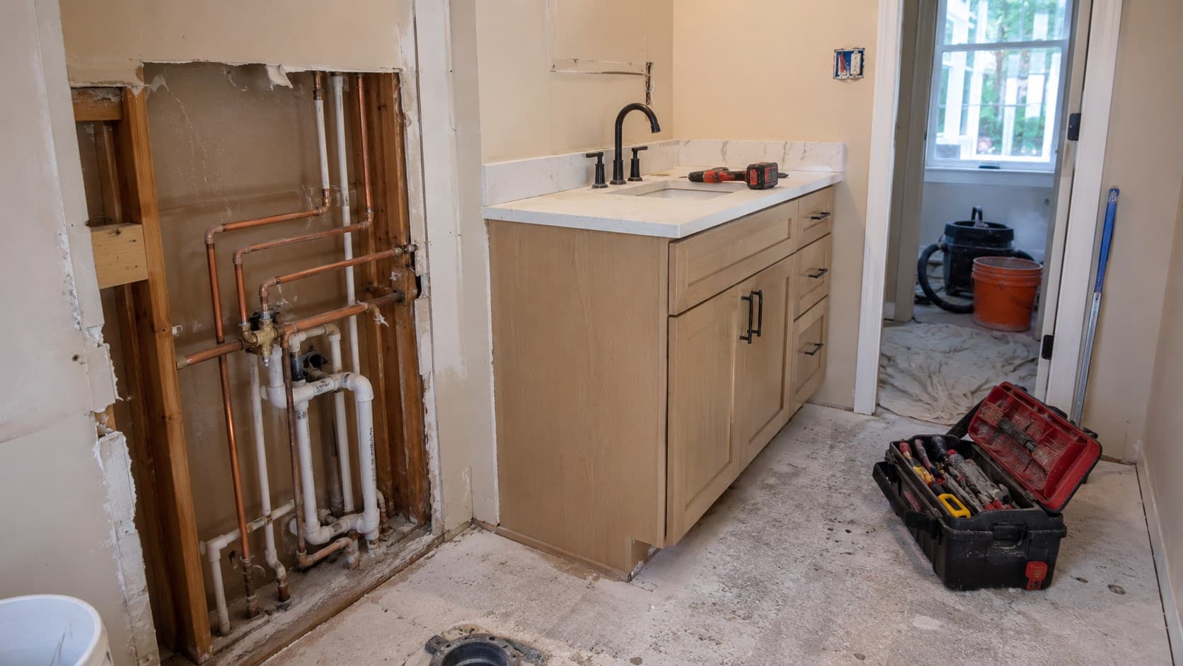 Bathroom plumbing and vanity installation in progress